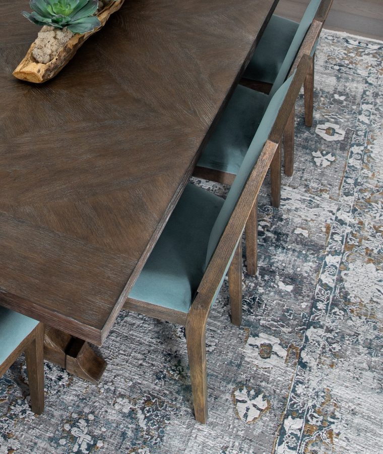 An intricate area rug adds depth and sophistication to a dining room.