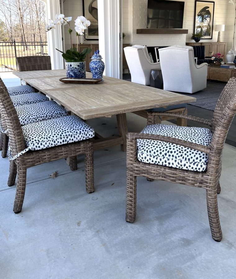 A gorgeous farm-style table is complemented by trendy outdoor chairs.