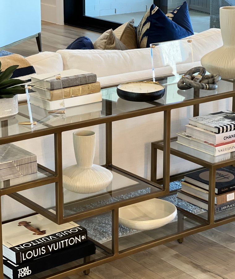 A decorative shelf in a living room provides a place to store items as well as a stylish accent to the room.